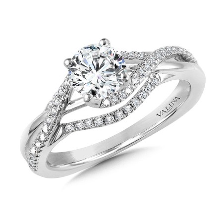 The shank splits into multiple ribbons of diamonds and gold. The outer ribbons attach, forming the lower shoulders of the ring. Whereas the inner four ribbons spiral around the center stone, perfectly forming around the diamond, becoming the ring head and