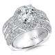 Three rows of diamonds in the band makes a big statement with this halo style engagement ring.