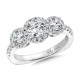 This special three stone engagement ring is completed with three diamond halos.