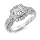 This princess center stone is embellished with a vintage-inspired, curvy cushion halo. From the halo, diamonds flow a third of the way down the shank. R1060W